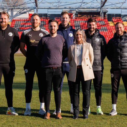 Line up of Gateshead FC and Dawson & Sanderson travel partners